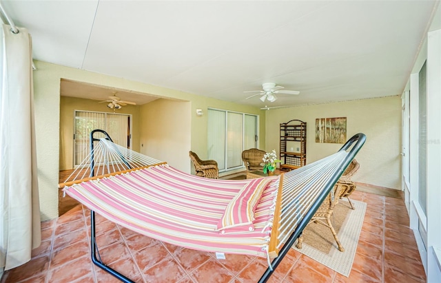 interior space with ceiling fan