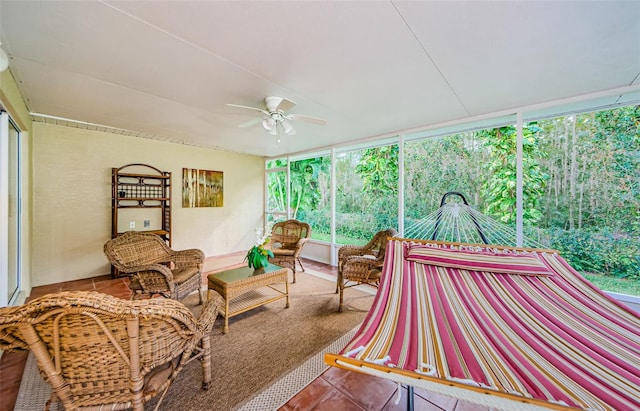 sunroom featuring ceiling fan