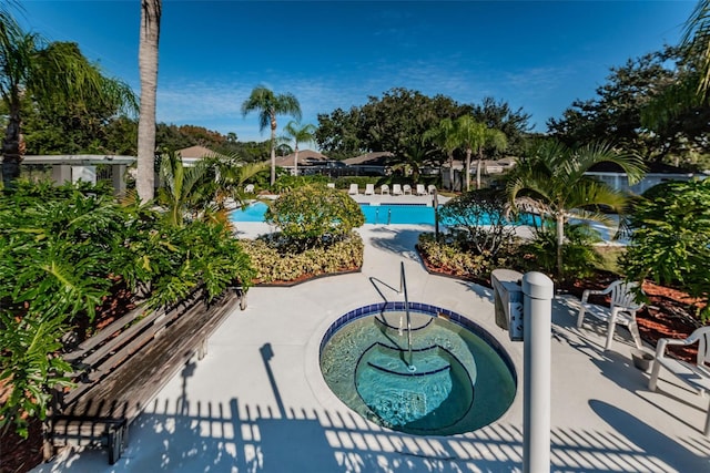 view of pool featuring a patio area and a hot tub