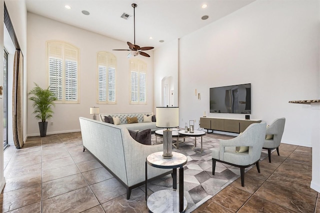 tiled living room with ceiling fan