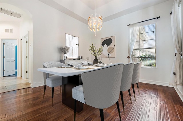 dining room featuring a notable chandelier and hardwood / wood-style flooring