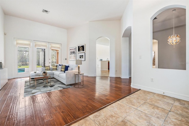 living room featuring light wood-type flooring and a chandelier