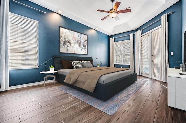 bedroom featuring a raised ceiling and ceiling fan