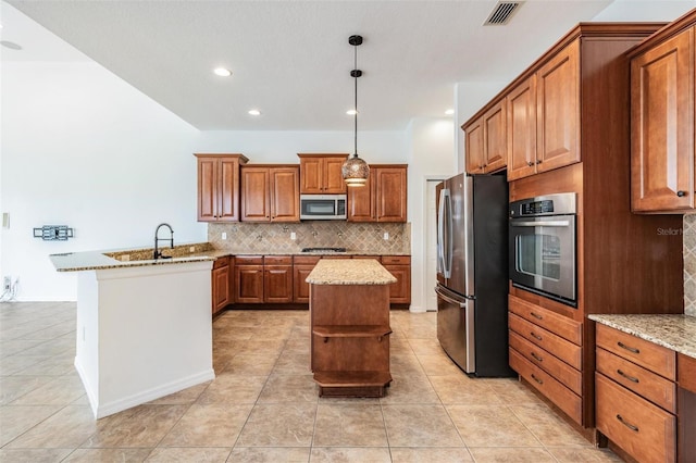 kitchen featuring a center island, kitchen peninsula, pendant lighting, decorative backsplash, and appliances with stainless steel finishes