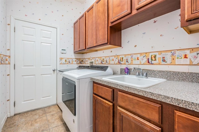 laundry room with washer and dryer, light tile patterned floors, cabinets, and sink