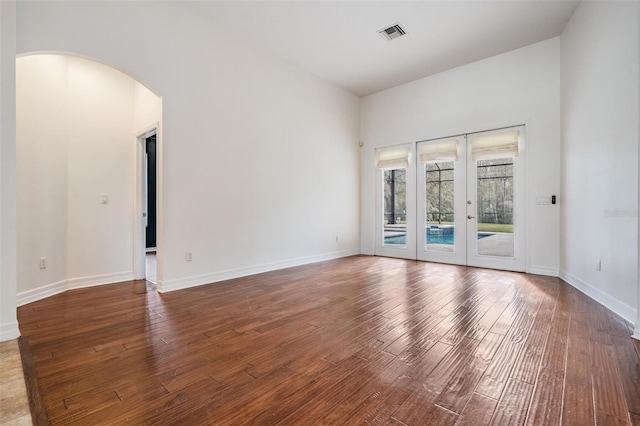 empty room with french doors and dark hardwood / wood-style floors