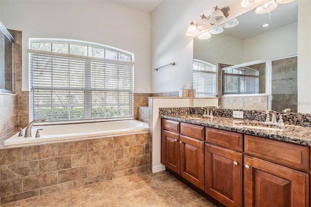 bathroom featuring tile patterned floors, vanity, a healthy amount of sunlight, and shower with separate bathtub