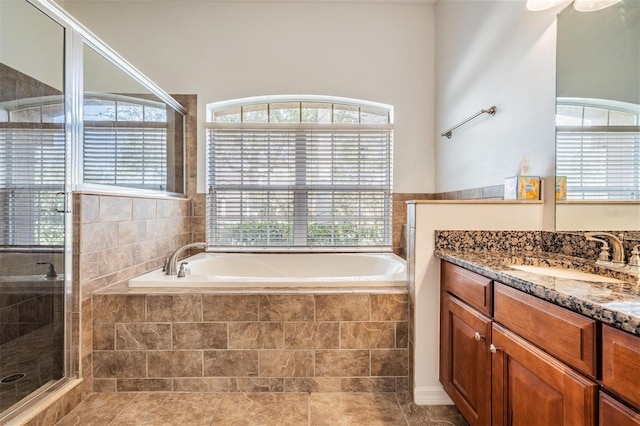 bathroom featuring tile patterned floors, vanity, and plus walk in shower