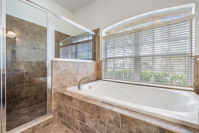 bathroom featuring tile patterned floors and shower with separate bathtub