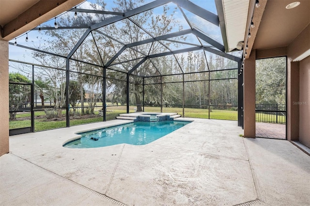 view of swimming pool featuring glass enclosure, a patio area, and an in ground hot tub