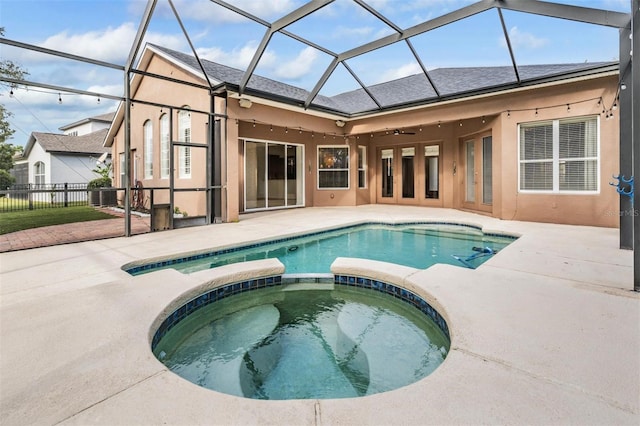 view of swimming pool with an in ground hot tub, ceiling fan, and a patio area