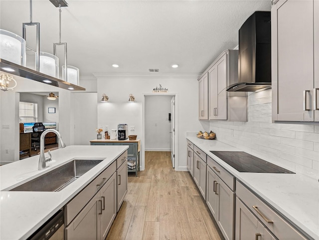 kitchen featuring pendant lighting, light hardwood / wood-style floors, wall chimney exhaust hood, and sink