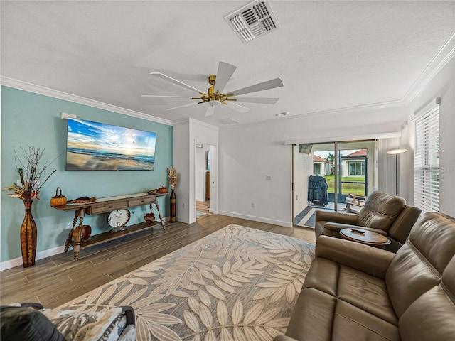 living room featuring ceiling fan, crown molding, a textured ceiling, and hardwood / wood-style flooring