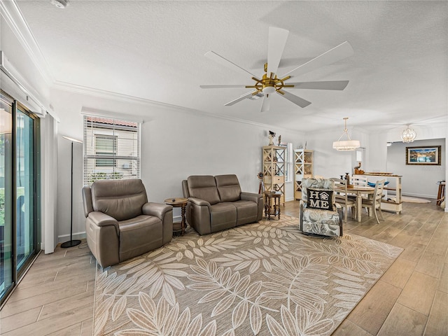 living room with a textured ceiling, light hardwood / wood-style floors, ceiling fan, and ornamental molding