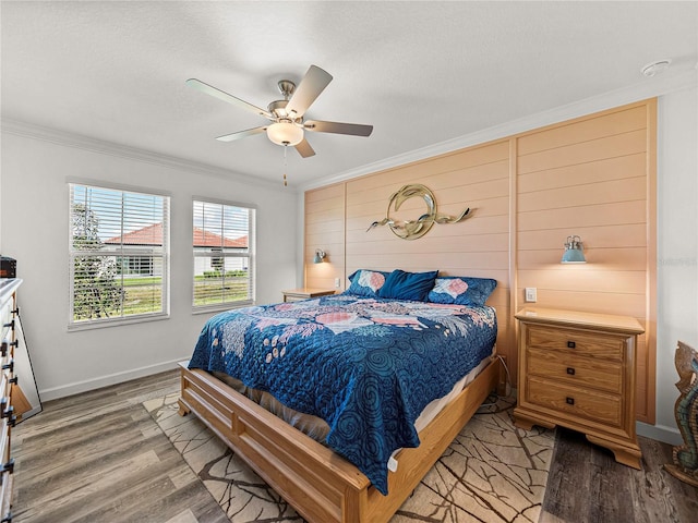 bedroom featuring ceiling fan, light hardwood / wood-style floors, and ornamental molding