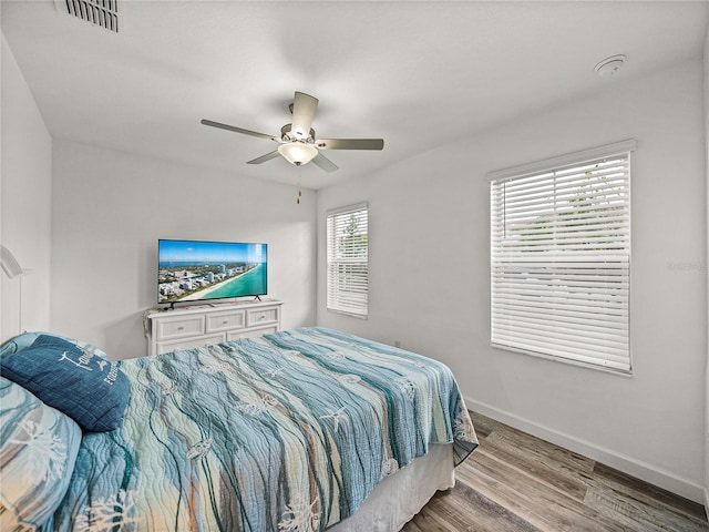 bedroom with ceiling fan and hardwood / wood-style floors