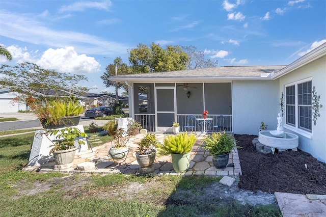 exterior space featuring a patio area, stucco siding, and a sunroom