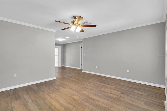 unfurnished room with ceiling fan, wood finished floors, visible vents, baseboards, and ornamental molding