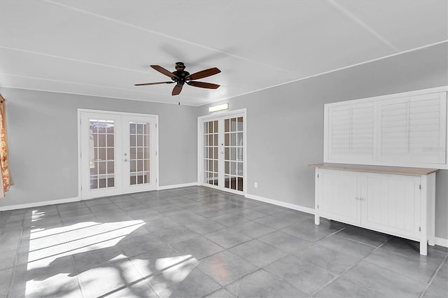 unfurnished living room with french doors, tile patterned floors, a ceiling fan, and baseboards