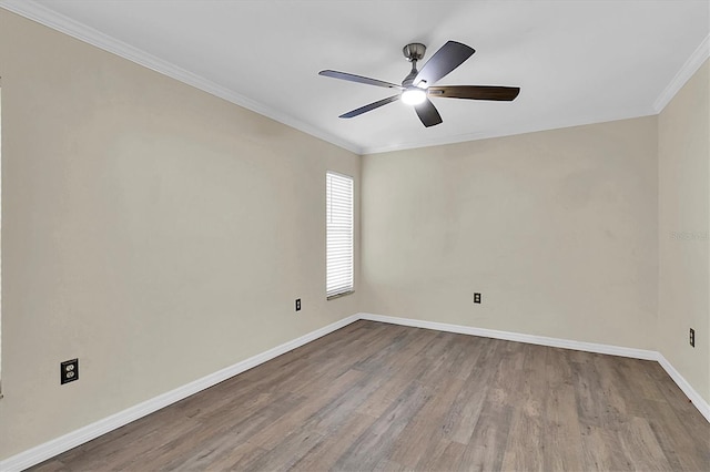 empty room featuring ornamental molding, wood finished floors, a ceiling fan, and baseboards