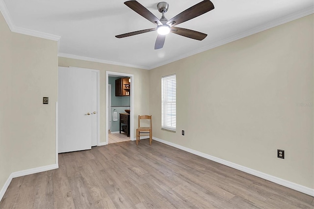 empty room with a ceiling fan, baseboards, light wood-style floors, and crown molding