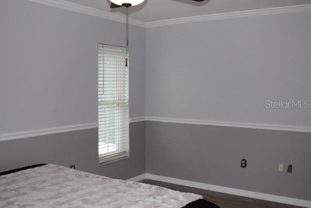 bedroom with ceiling fan, baseboards, and ornamental molding