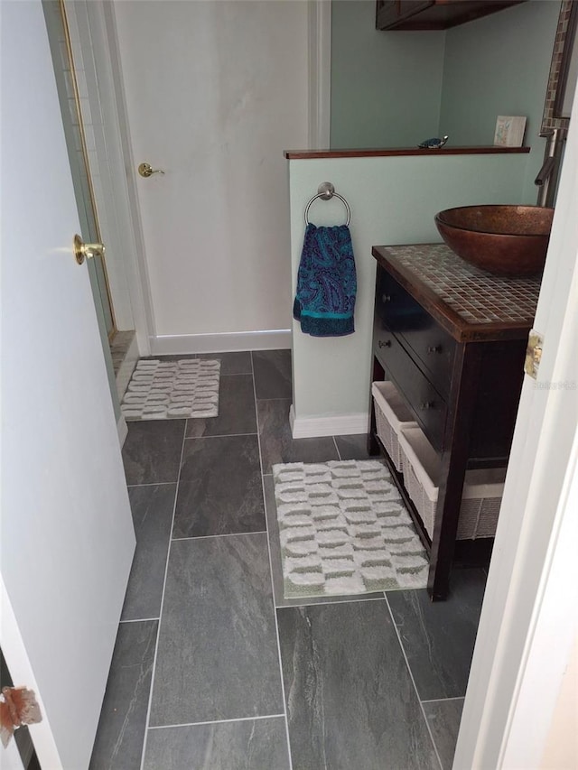 bathroom with baseboards and vanity