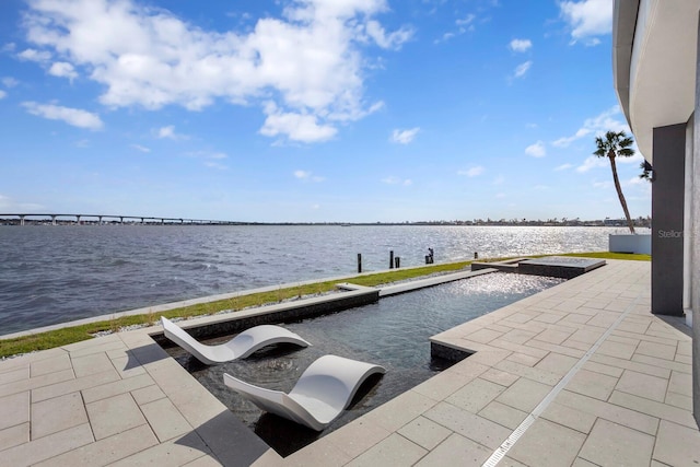 view of patio with a water view