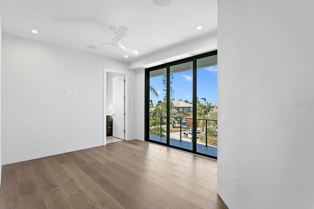 spare room with light hardwood / wood-style floors and ceiling fan