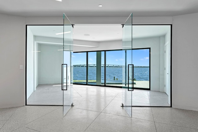 unfurnished room featuring a water view