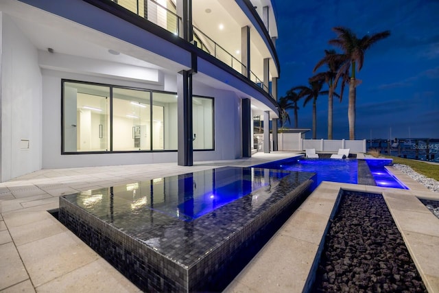 view of pool featuring a jacuzzi, a patio, and pool water feature