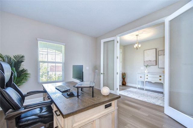 office space featuring hardwood / wood-style flooring, french doors, and an inviting chandelier