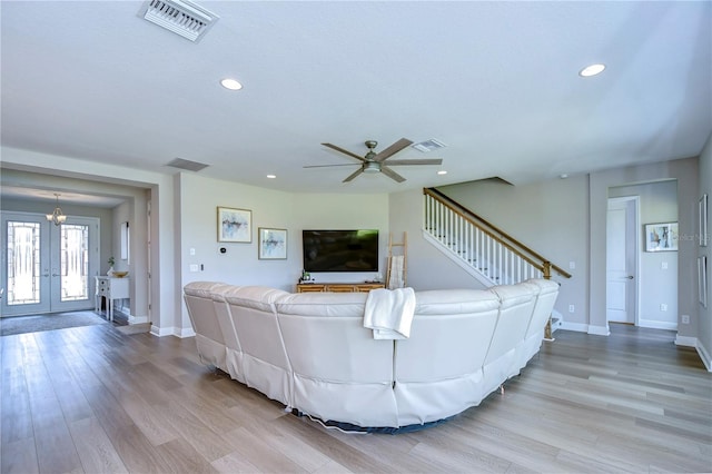 unfurnished living room featuring french doors, light hardwood / wood-style floors, and ceiling fan