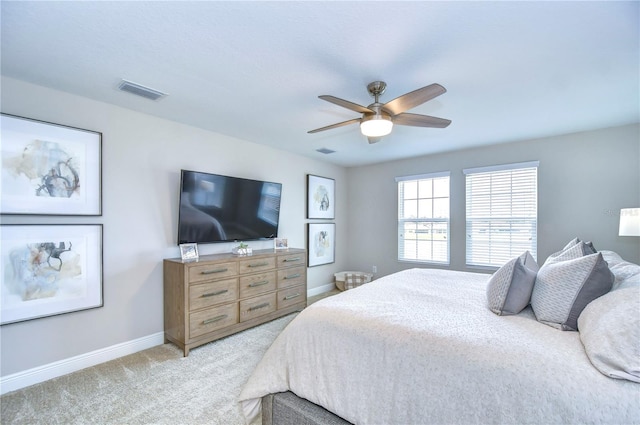 bedroom featuring light carpet and ceiling fan