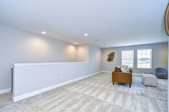 sitting room featuring light colored carpet