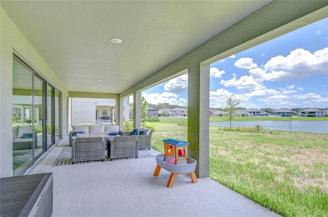 view of patio with an outdoor living space and a water view