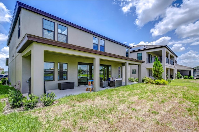 rear view of house featuring an outdoor hangout area, a patio, and a yard