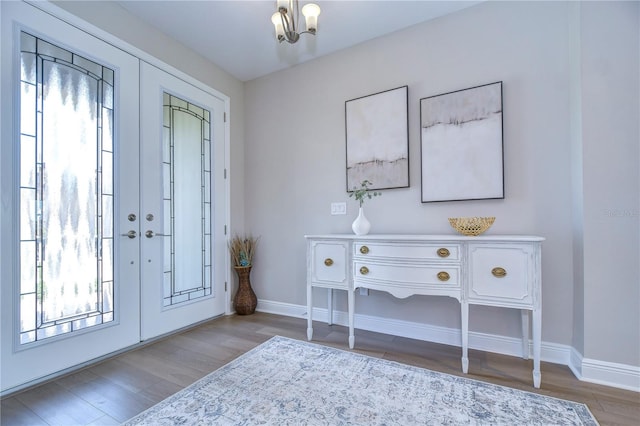 foyer featuring a chandelier, hardwood / wood-style flooring, and a healthy amount of sunlight