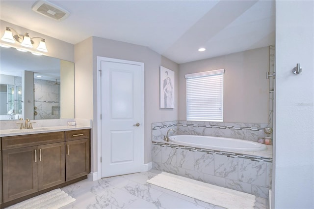 bathroom featuring vanity and shower with separate bathtub