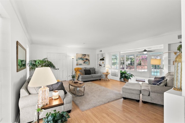 living room featuring crown molding and hardwood / wood-style floors