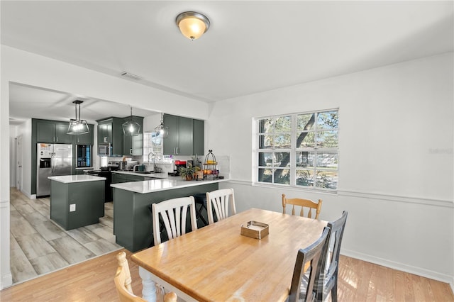 dining room featuring light hardwood / wood-style floors and sink