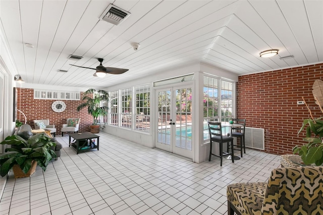 sunroom / solarium featuring french doors and ceiling fan