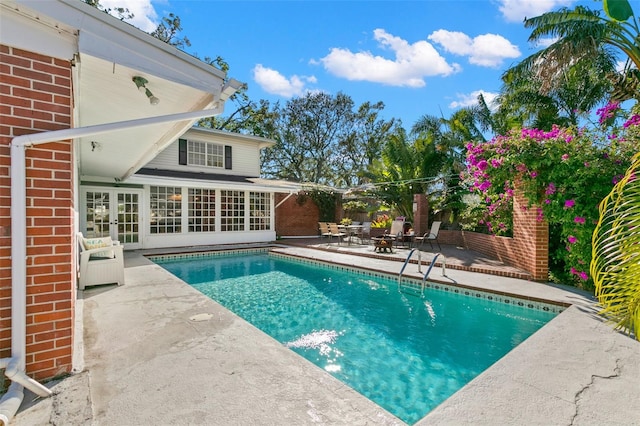 view of pool with a patio and french doors