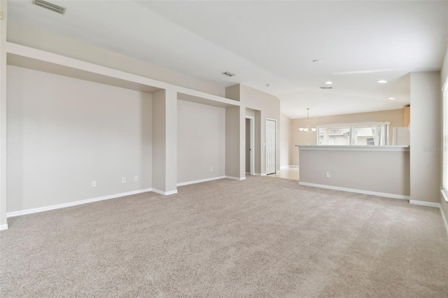 interior space with light colored carpet and a notable chandelier