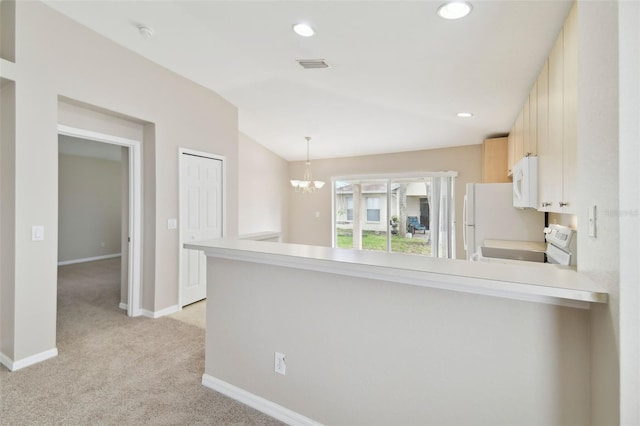 kitchen featuring light carpet, white appliances, kitchen peninsula, and hanging light fixtures