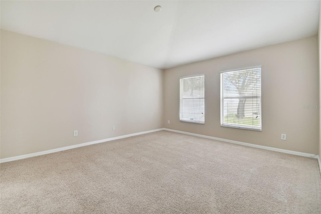 spare room featuring light colored carpet