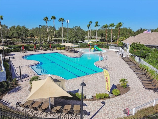 view of pool featuring a patio and a water slide