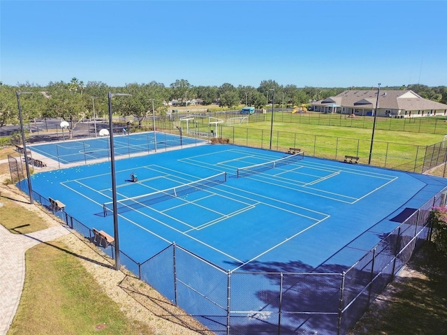 view of sport court with a yard