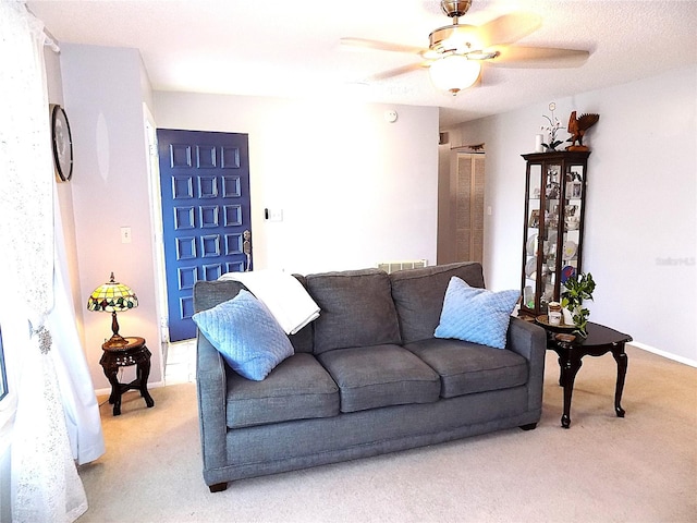 carpeted living room featuring a textured ceiling and ceiling fan