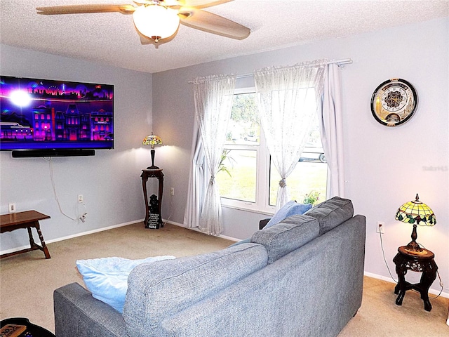 living room featuring carpet flooring, ceiling fan, a healthy amount of sunlight, and a textured ceiling